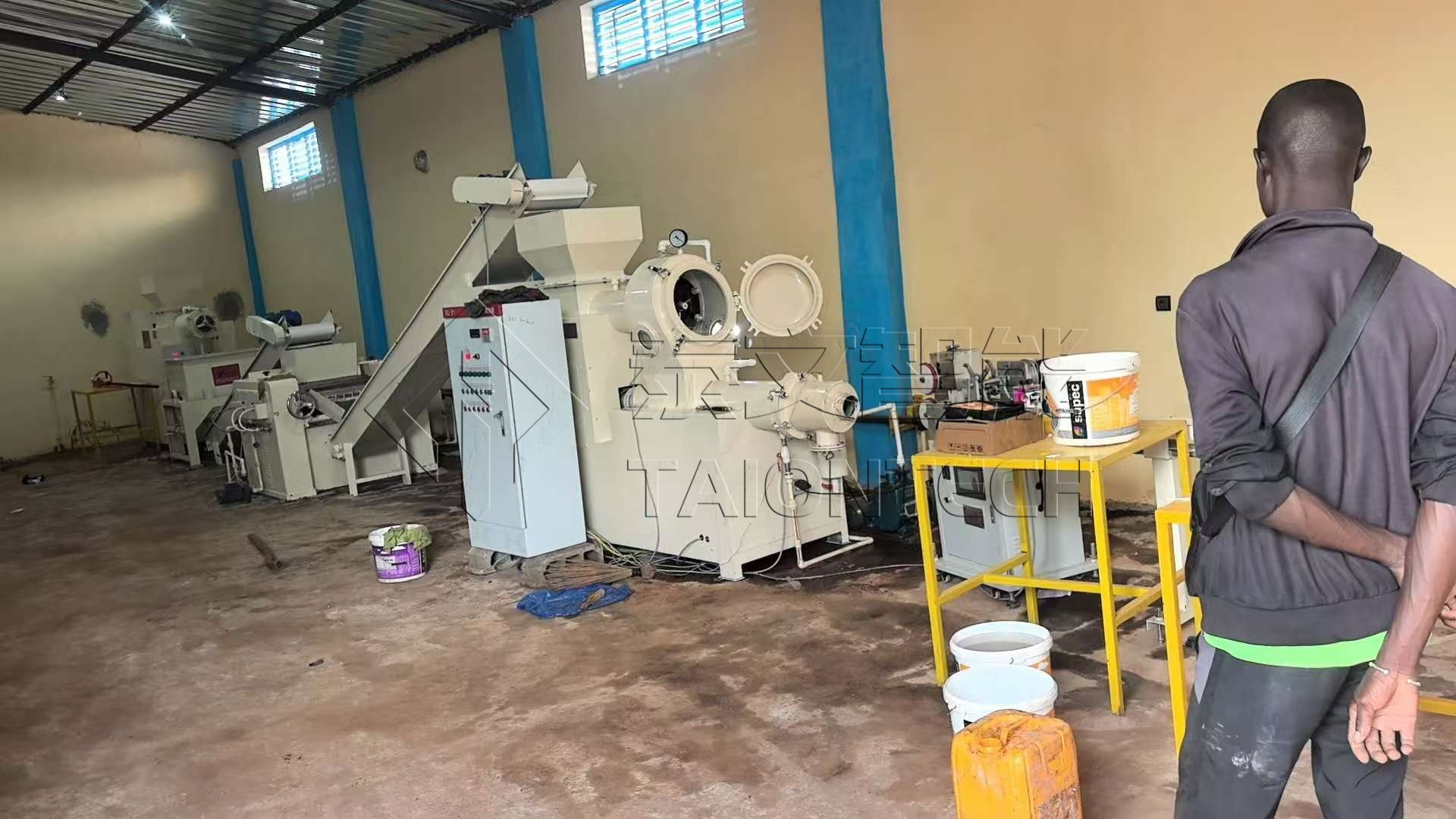 Interior of manufacturing plant with machinery and workers